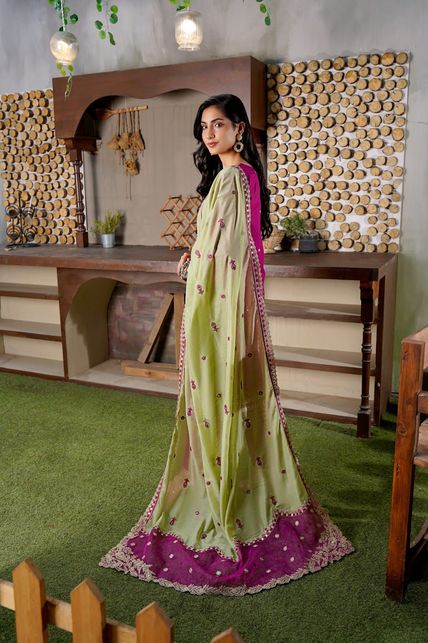 Woman in a pistachio green suit with a woven dupatta