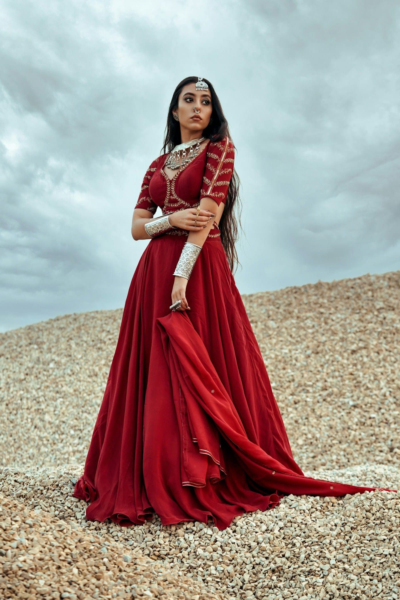 Woman in a crimson draped gown outdoors