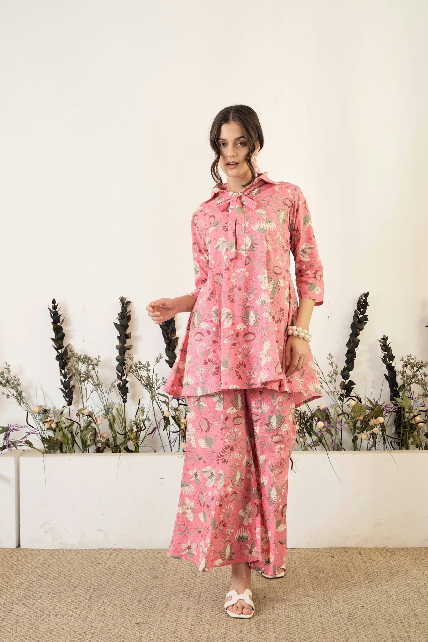 Woman in a pink printed co-ord set with palazzo trousers